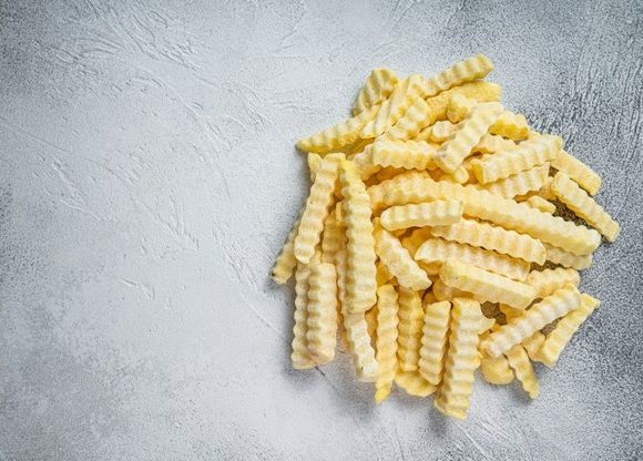 frozen crinkle french fries potatoes sticks white background top view copy space_89816 29764 1 580x416